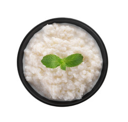 Delicious rice pudding with mint in bowl on white background