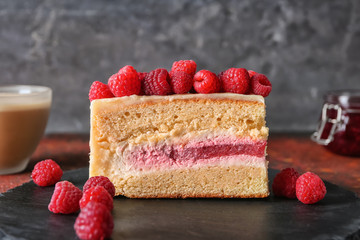 Piece of delicious raspberry cake on slate plate, closeup