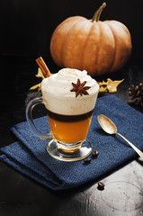 Pumpkin spice  latte with whipped cream on black board, copy space.