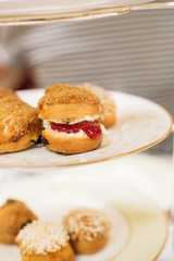 Fototapeta na wymiar Scones with Strawberry Champagne Jam and Clotted Cream, Traditional English Tea Ceremony in Luxury Hotel