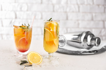 Glassware of tasty cold cocktails on white table
