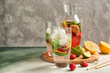 Glassware of fresh strawberry lemonade on table
