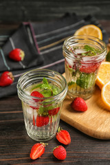 Jars of fresh strawberry lemonade on  wooden table