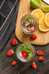 Jars of fresh strawberry lemonade on  wooden table