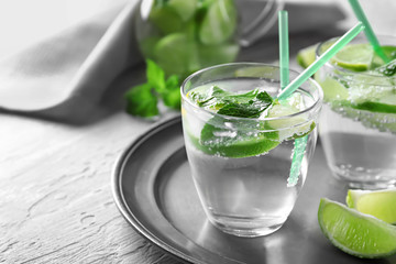 Glasses of fresh mojito on metal tray