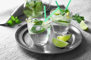 Glasses of fresh mojito on metal tray