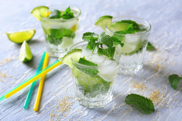 Glasses of fresh mojito on light table