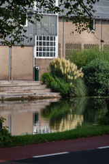Image of the interesting façade with reflection in canal water