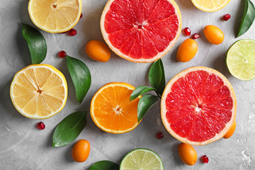 Naklejka na ściany i meble Flat lay composition with various delicious citrus fruits on light background