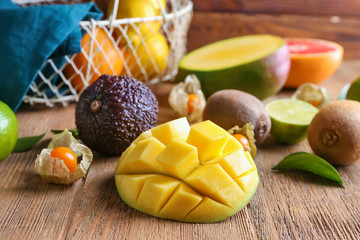 Various delicious exotic fruits on wooden table