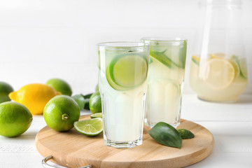 Glasses of fresh lime lemonade on wooden board
