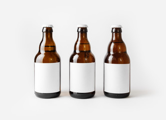 Three brown beer bottles with blank labels.