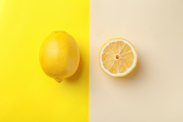 Ripe lemon and slice on color background