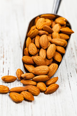 Scoop Full of Organic Raw Almonds Nuts. Selective focus.