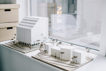 white architecture models on windowsill in light modern office