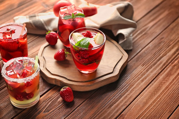 Fresh summer cocktails in glasses on wooden table