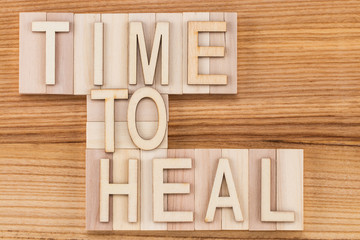 time to heal-  text in vintage letters on wooden blocks. Medicine concept