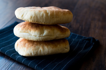 Asian Gua Bao Bun Pita Bread on Wooden Surface.