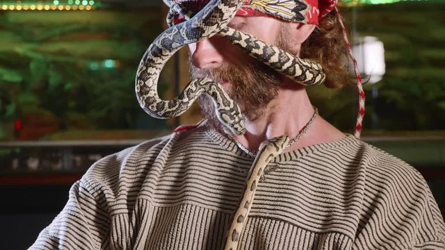 Snake on the man's face. Terrible video with snakes in role of domestic pets.