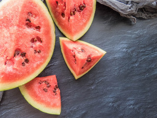 ripe red watermelon on a dark background Summer food background healthy eating. eco-friendly products. organic fruits. copyspace. Organic Food. Top View