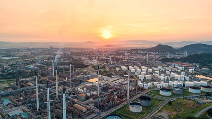 Industrial view at oil refinery plant form industry zone with sunrise and cloudy sky.Oil refinery and Petrochemical plant at dusk,Thailand. Aerial view