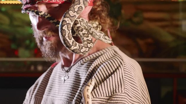 Snake on the man's face. Terrible video with snakes in role of domestic pets.