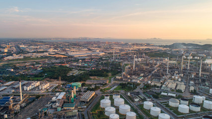 Industrial view at oil refinery plant form industry zone with sunrise and cloudy sky.Oil refinery and Petrochemical plant at dusk,Thailand. Aerial view