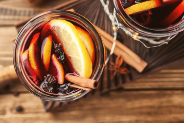 Jar of delicious mulled wine on wooden board