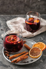Glass of delicious mulled wine on metal tray