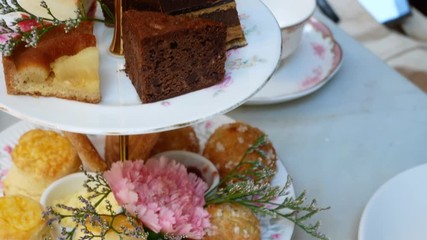 High tea tray with many sweet dessert -(Cake,Scone,Biscuit) for traditional english tea time