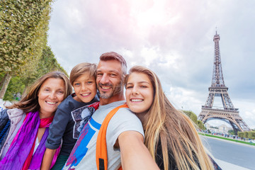 Happy family having fun together in Paris near the Eiffel tower