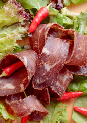 Dry beef jerky with herbs and red peppers.
