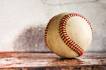 Old baseball on shabby metal textured background. Macro view ball, shallow depth of field, copy space