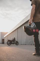 biker guy in front of classic style motorcycle