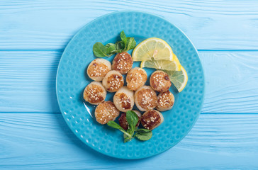 Fried scallops with lemon and salad