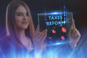 The concept of business, technology, the Internet and the network. A young entrepreneur working on a virtual screen of the future and sees the inscription: taxes reform