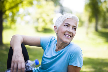 Portrait of smiling senior woman relaxing after exercising