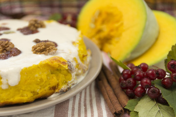 Pumpkin homemade cheesecake with white cream. Autumn still life. Thanksgiving day food.