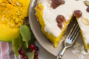 Pumpkin homemade cheesecake with white cream. Autumn still life. Thanksgiving day food.
