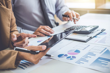 Business people conference and discussing the charts and graphs showing the results of their successful teamwork, business concept