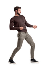 A bearded man a jumper and pants tries to pull a strong invisible rope on a white background.