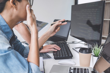 Writing codes and typing data code technology, Programmer cooperating working on web site project...