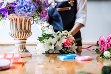 Arranging artificial flowers vest decoration at home, Young woman florist work making organizing diy artificial flower, craft and hand made concept