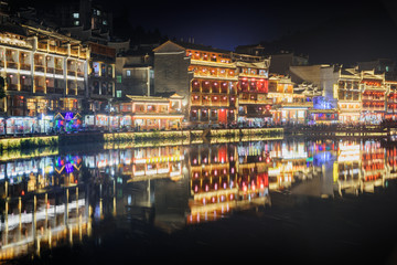 Fototapeta na wymiar Colorful Chinese buildings reflected in water, Fenghuang