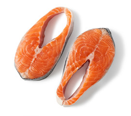 Raw salmon steaks slices, isolated on a white background. Top view.