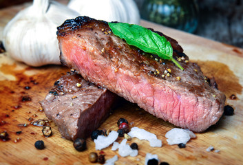 Medium rare beef steak grill in charcoal flamimg