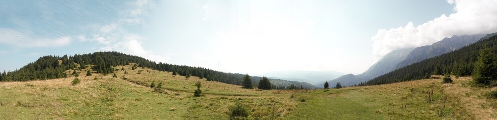 Mountainous landscape with clouds and blue sky