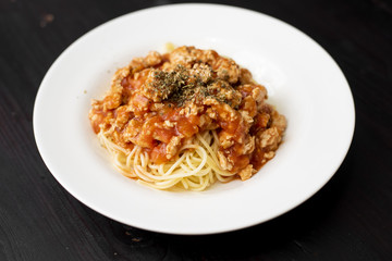 Spaghetti on black wooden background