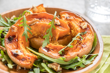 Autumn pumpkin salad with arugula and walnut