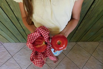 girl holding tomatoes